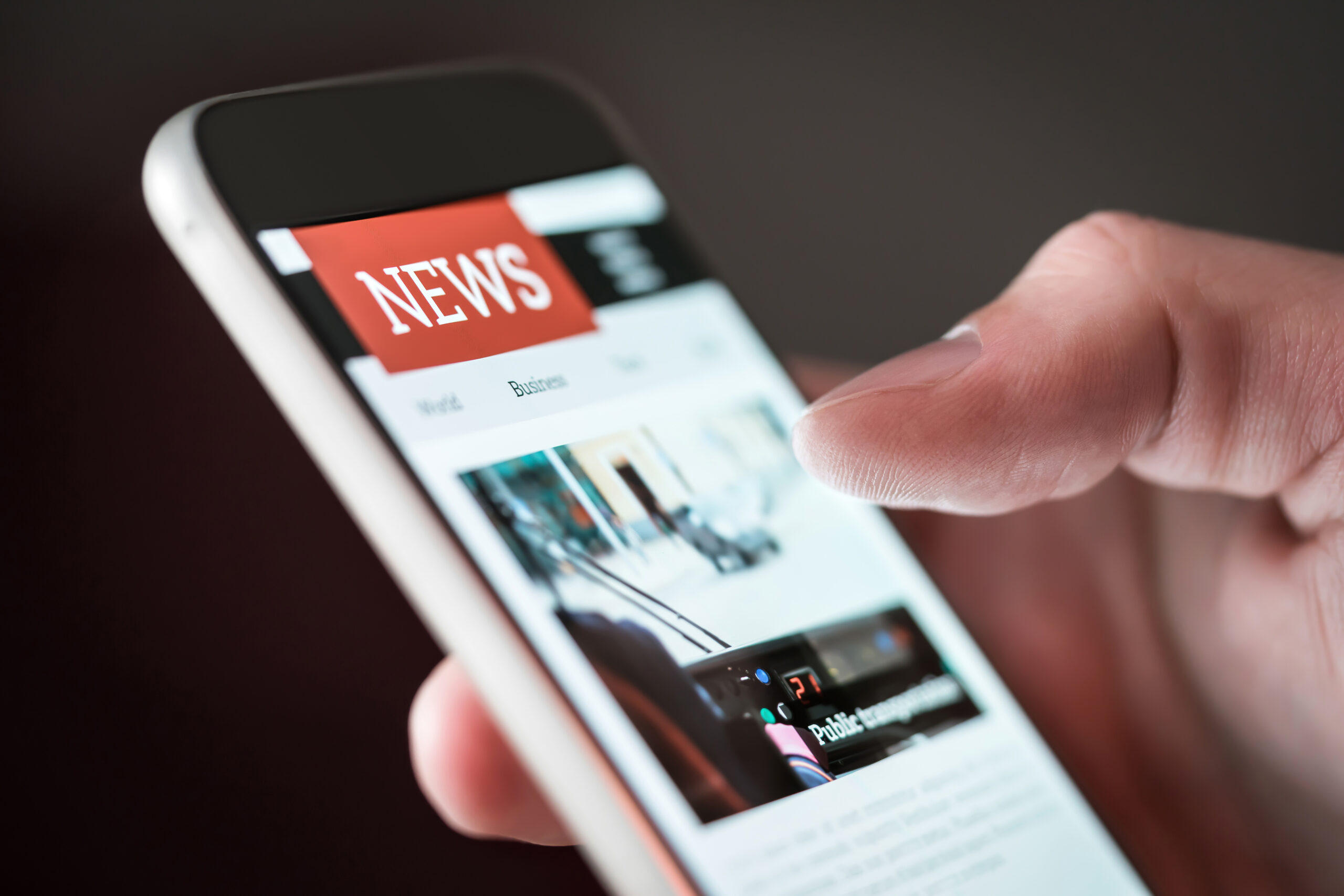 Mobile news application in smartphone. Man reading online news o
