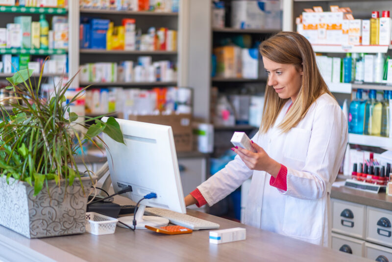 Female pharmacist working in chemist shop or pharmacy. Pharmacis