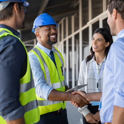 Engineer and businessman handshake at construction site