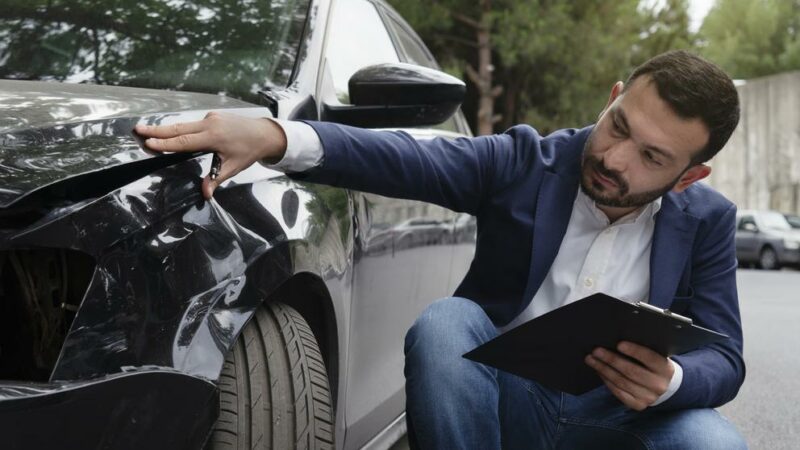 Inspecting Car Damage After A Crash