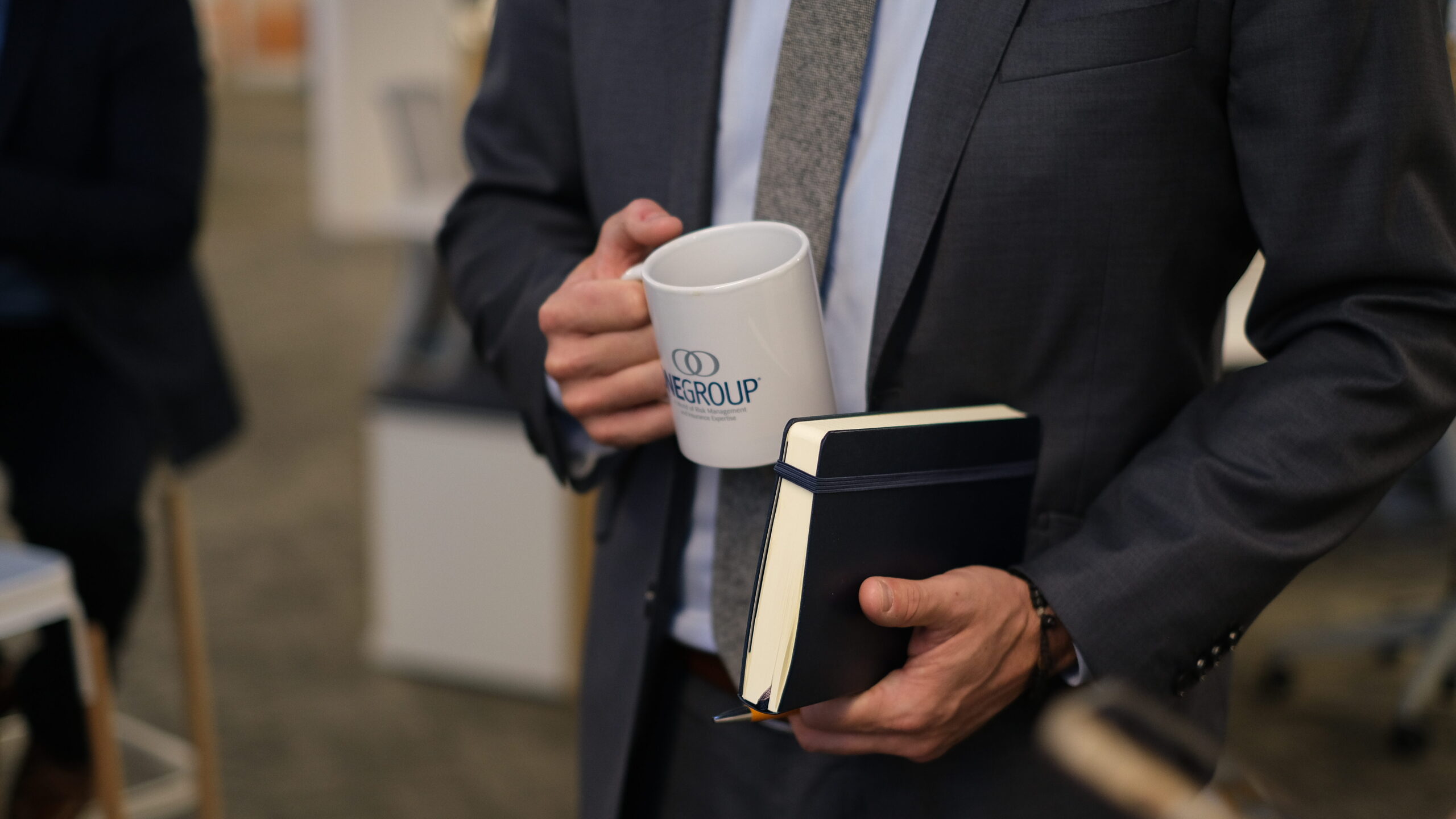 OG Coffee Mug Man Holding Mug and Notebook