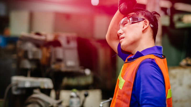 Tired worker, headache hot weather over heat unhealthy engineer working in heavy industry factory.