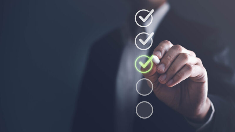 Businessman touching to tick correct sign mark in checkbox for quality document control checklist and business approve project concept.
