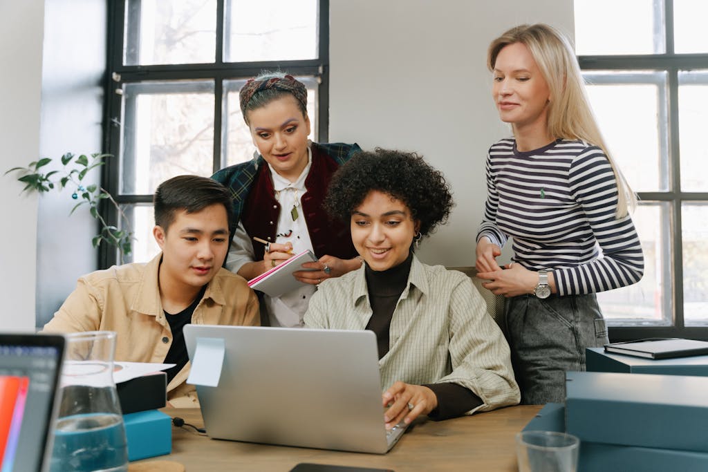 A Group of People Looking at a Laptop