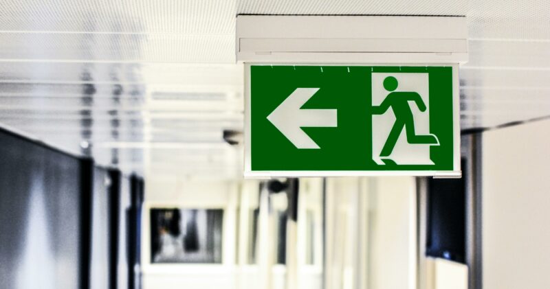 Green evacuation sign which is a good way to identify exits during an emergency evacuation plan in a municipality building