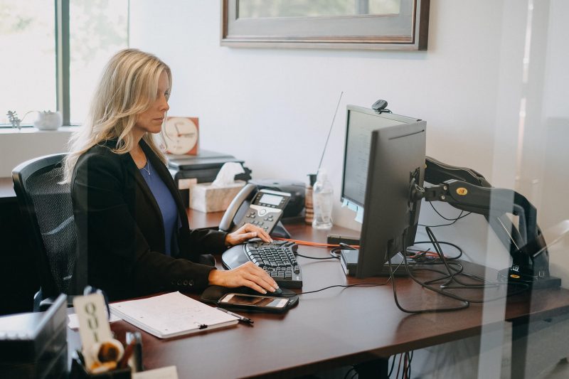 Woman managing claims at a desk on a computer