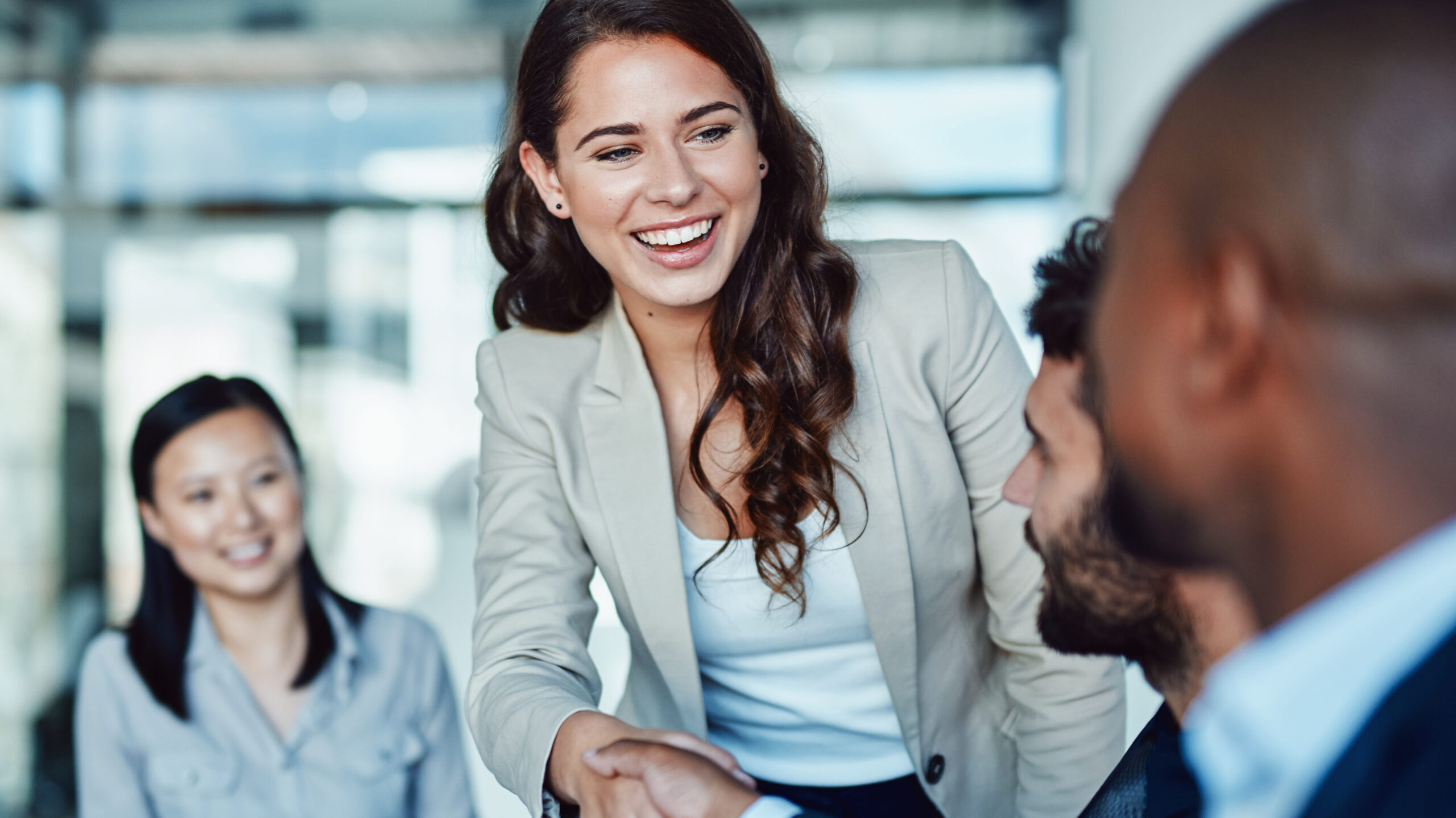 Shot of a young businesswoman shaking hands with a colleague during a meeting in a modern office